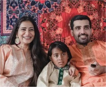a man and woman sitting next to a child