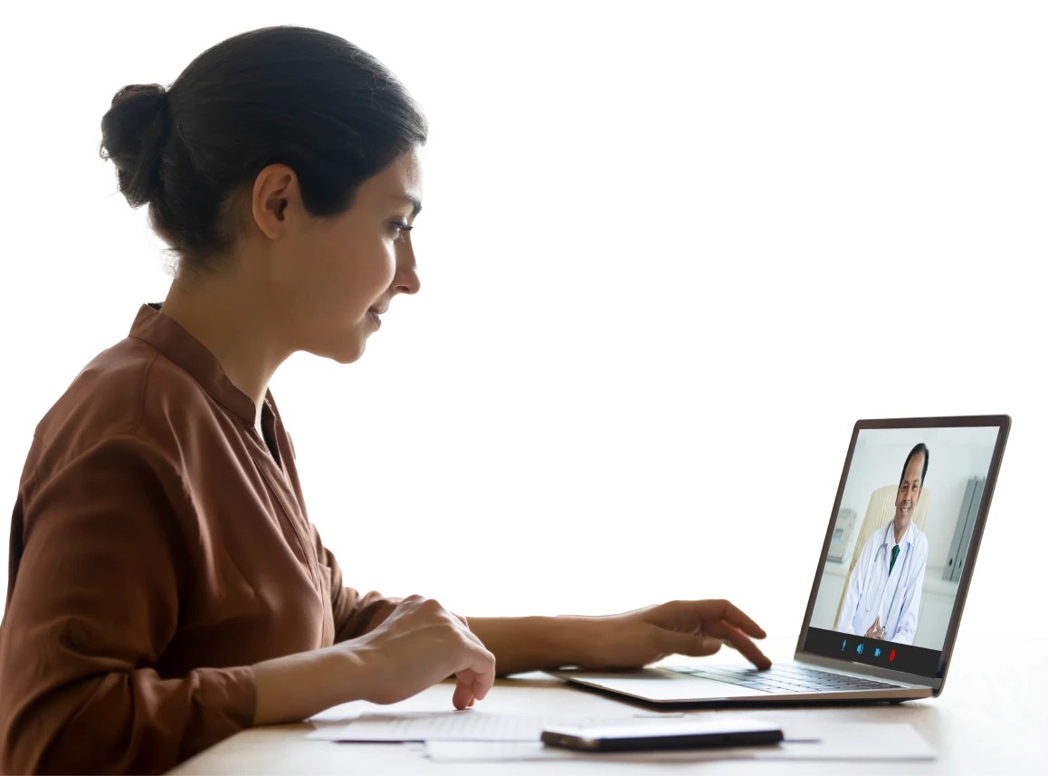 a woman sitting at a desk using a laptop computer