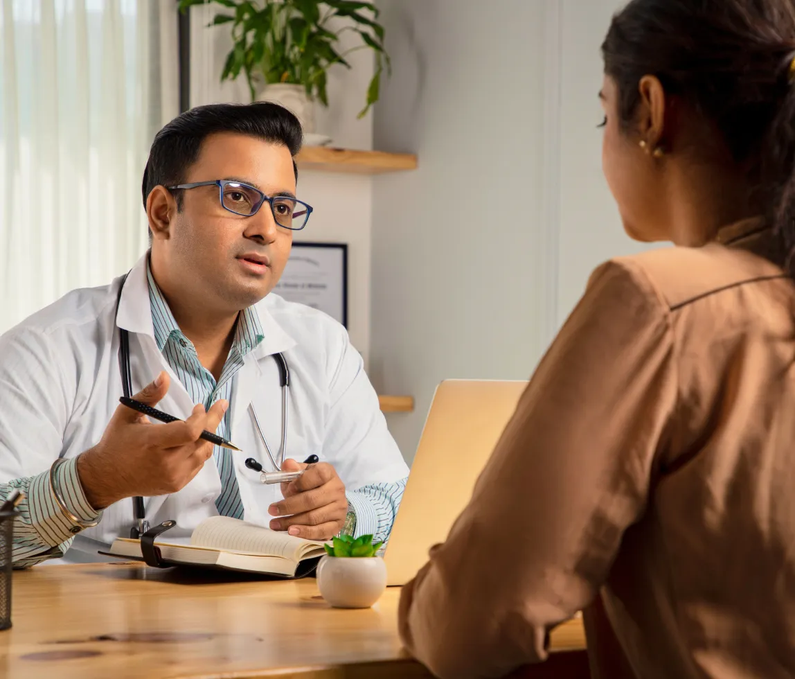 a doctor talking to a patient at a desk