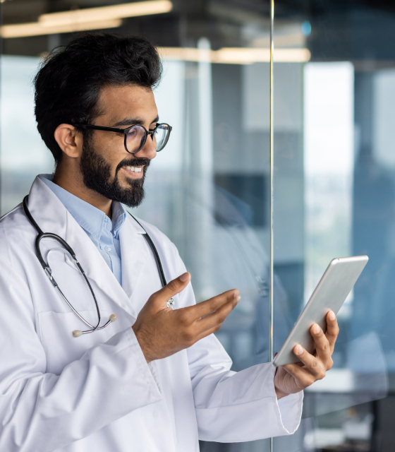 a man in a lab coat using a tablet