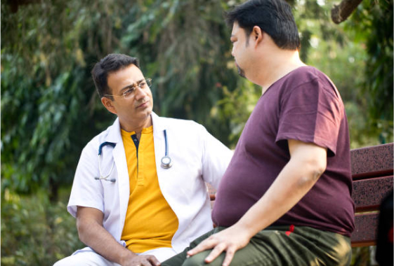 a doctor talking to a patient sitting on a bench