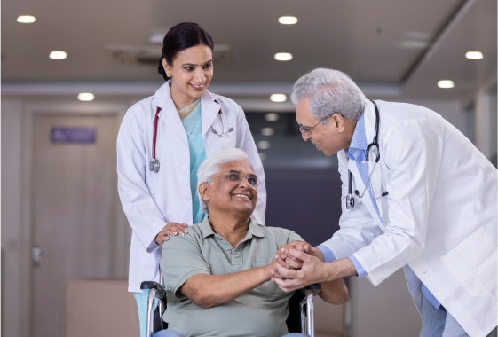 a woman in a wheelchair shaking hands with a man in a white coat